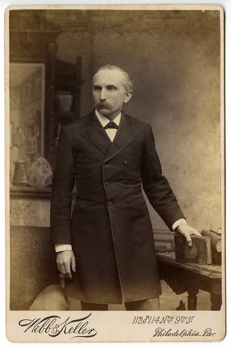 Unidentified man posing with book (Philadelphia, late 19th century). Cabinet card photograph.